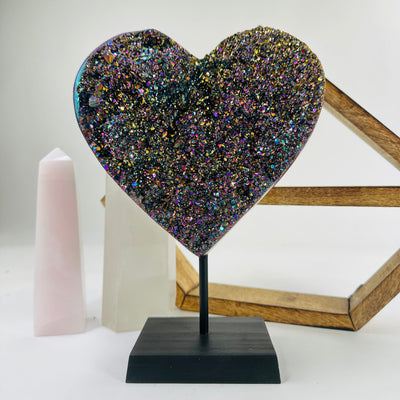 amethyst heart on stand with decorations in the background