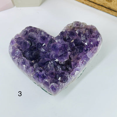 AMTHYST HEARTS WITH DECORATIONS IN THE BACKGROUND