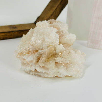 pink halite cluster with decorations in the background