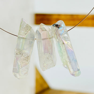 aura quartz crystal with decorations in the background