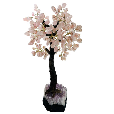 rose quartz tree on amethyst base on white background