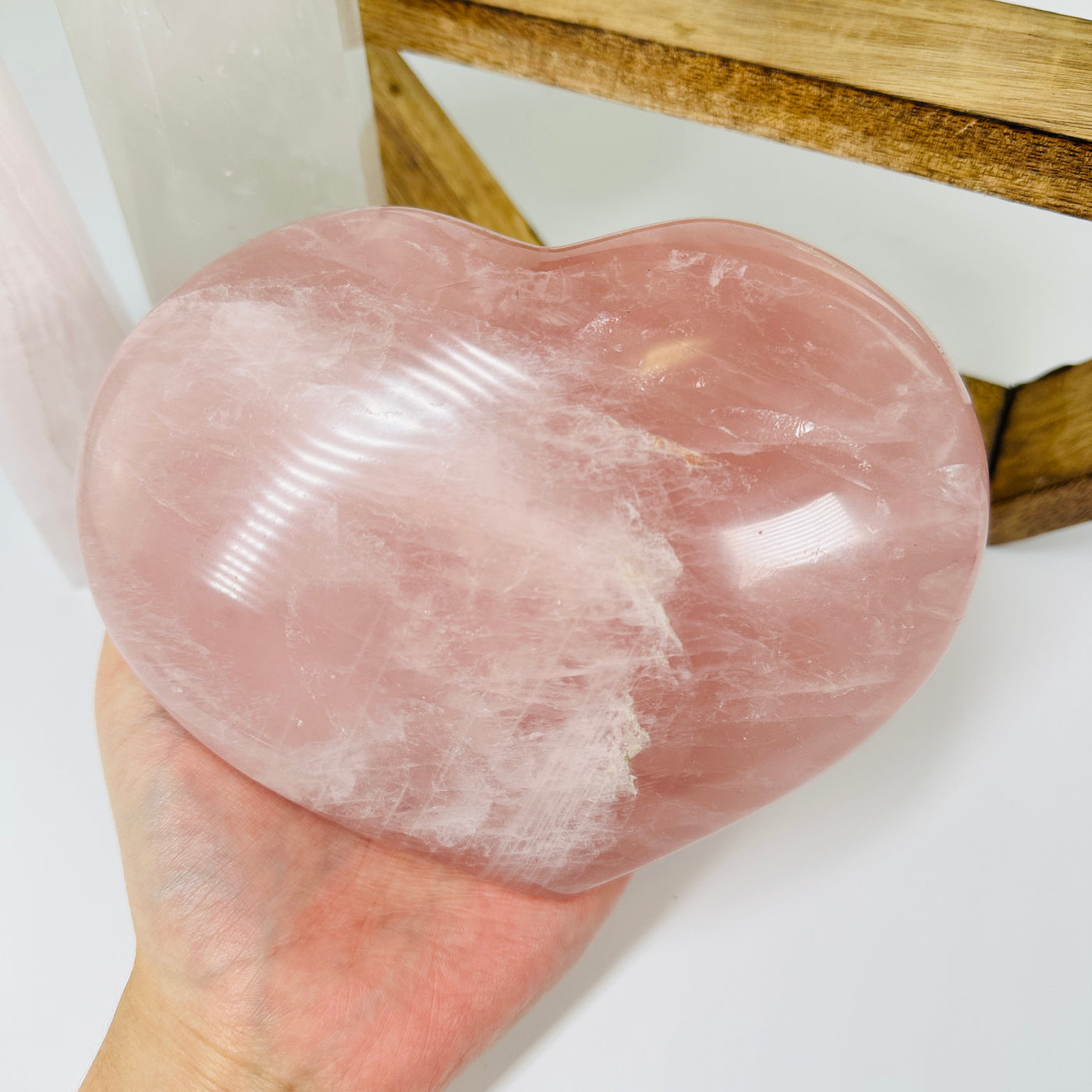 rose quartz heart with decorations in  the background