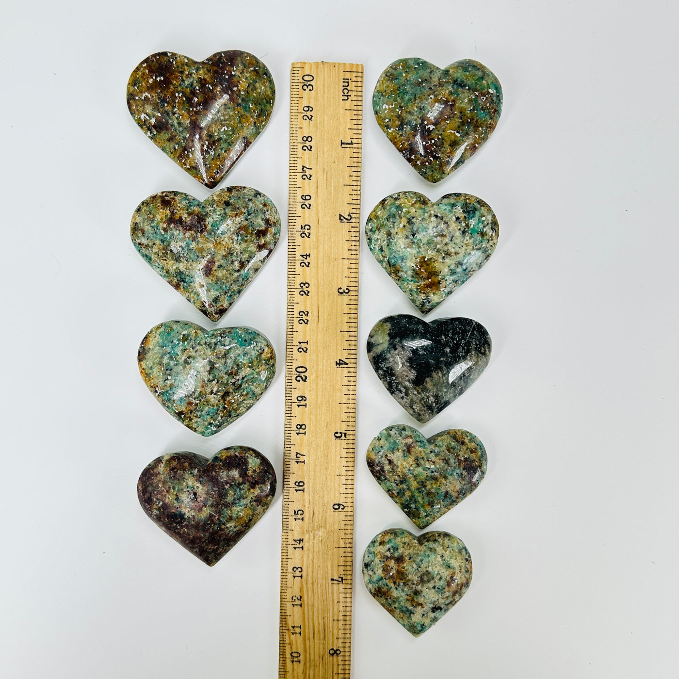 amazonite heart with decorations in  the background