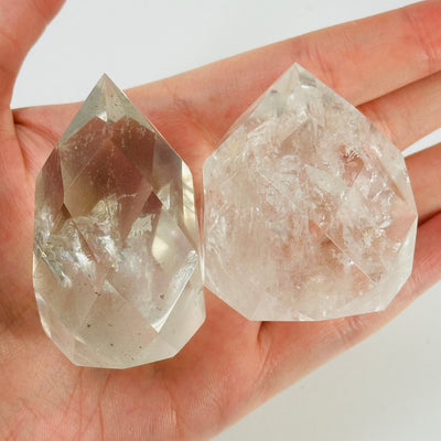 crystal quartz point with decorations in the background