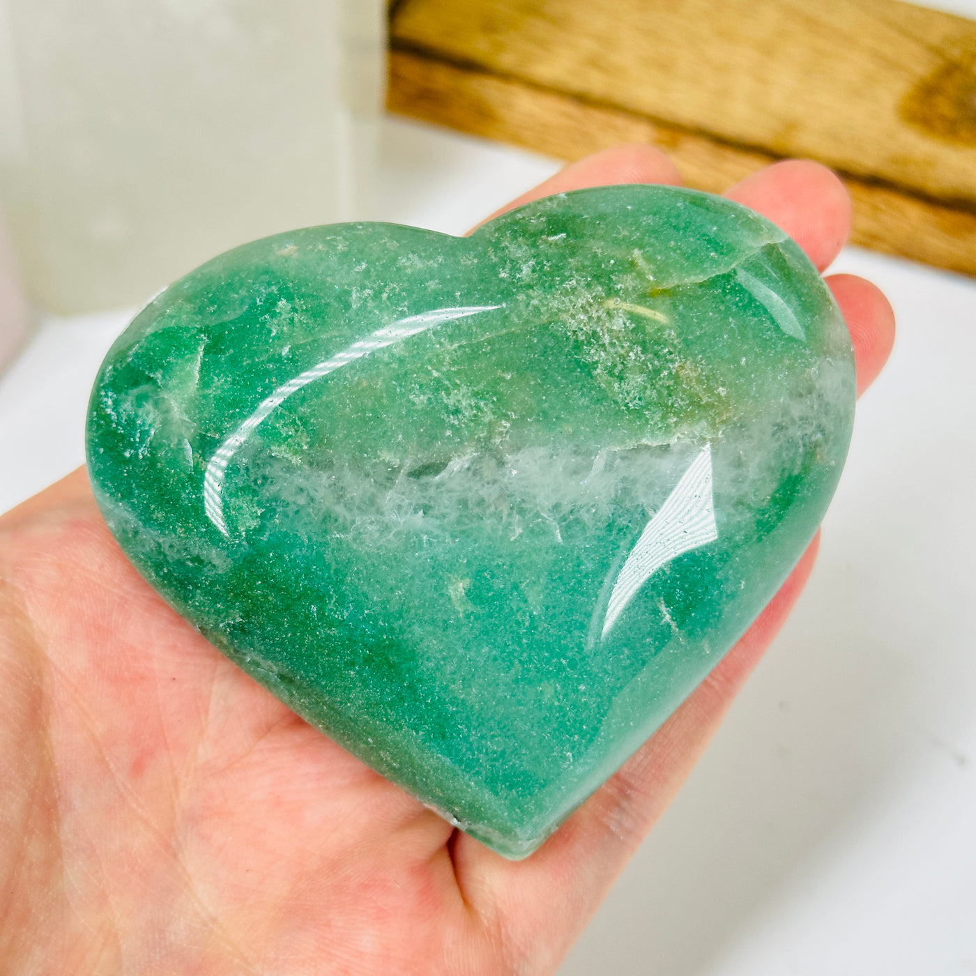 aventurine heart with decorations in  the background