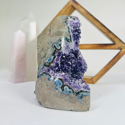 amethyst cluster with decorations in the background