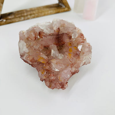 lithium quartz cluster with decorations in the background 