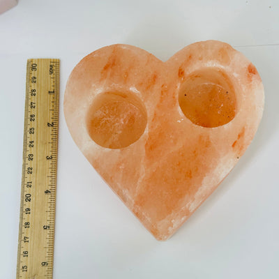 Himalayan salt candle holder next to a ruler for size reference