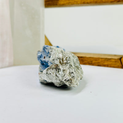 kyanite cluster with decorations in the background