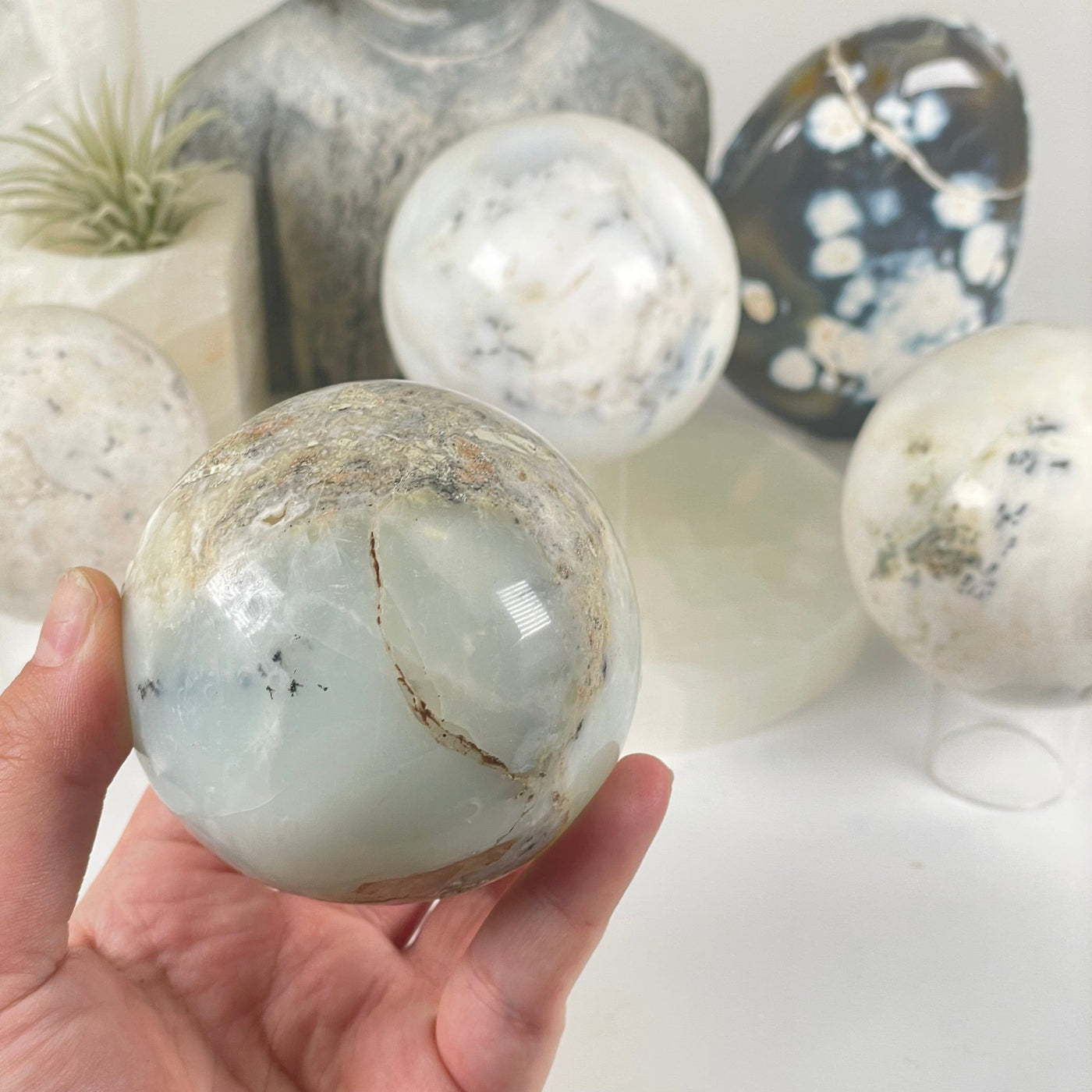 Dendritic Opal Crystal Sphere - As Is - You Choose one in hand for size reference with other variants in the background