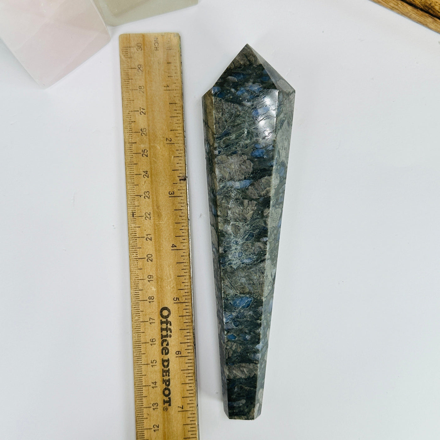 rhyolite point next to a ruler for size reference