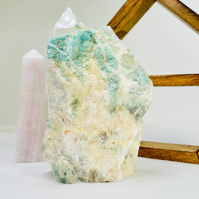 amazonite cut base with decorations in the background