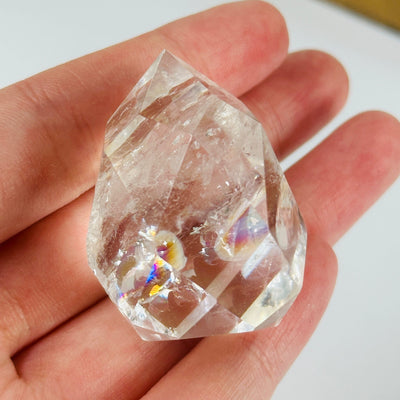 crystal quartz point with decorations in the background