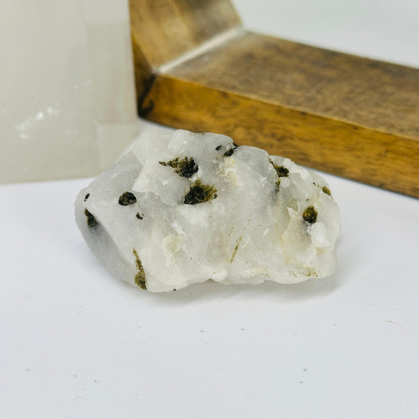 epidote on matrix with decorations in the background