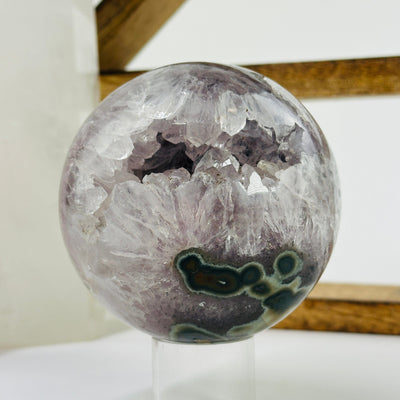 amethyst sphere with decorations in the background