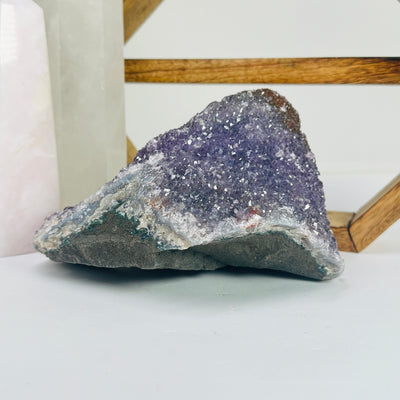 amethyst cluster with decorations in the background