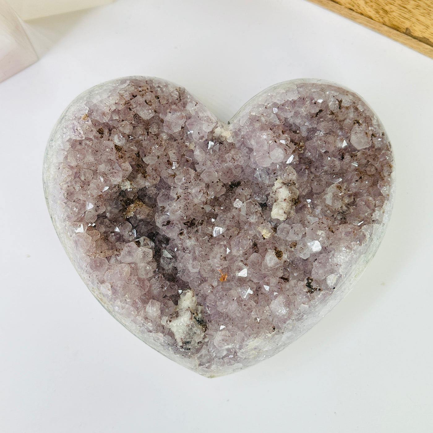 amethyst heart with decorations in the background