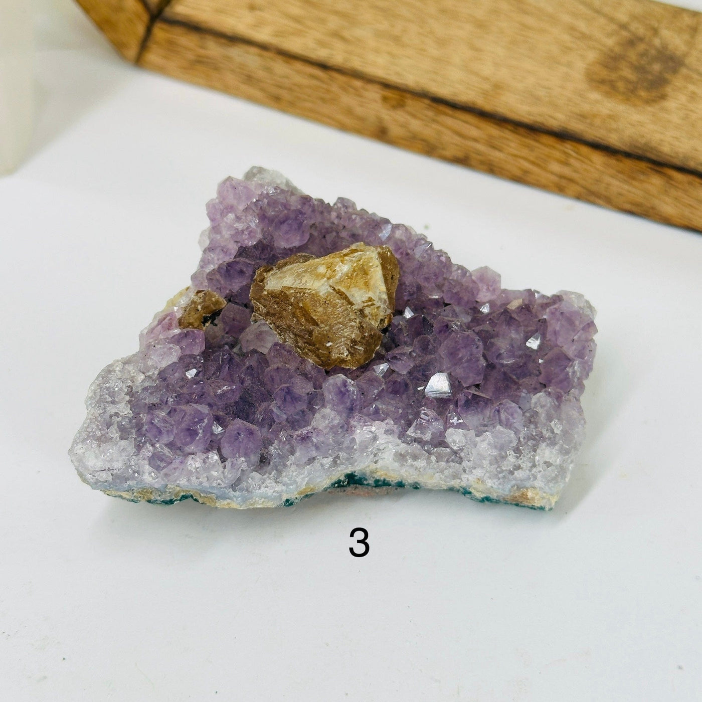 amethyst cluster with decorations in the background