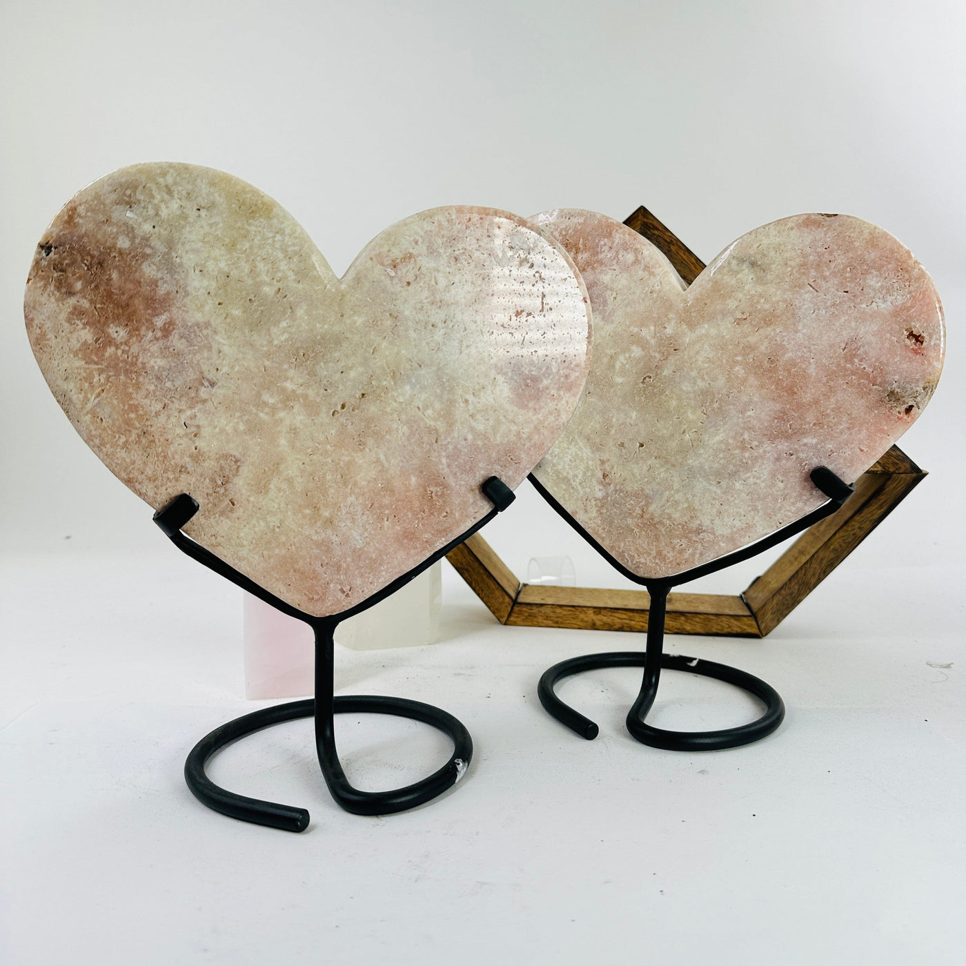 pink amethyst heart on metal stand with decorations in the background