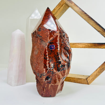 mahogany obsidian point with decorations in the background