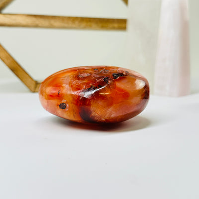 carnelian heart with decorations in the background