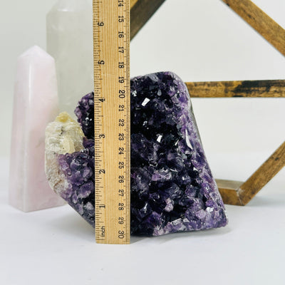 amethyst next to a ruler for size reference