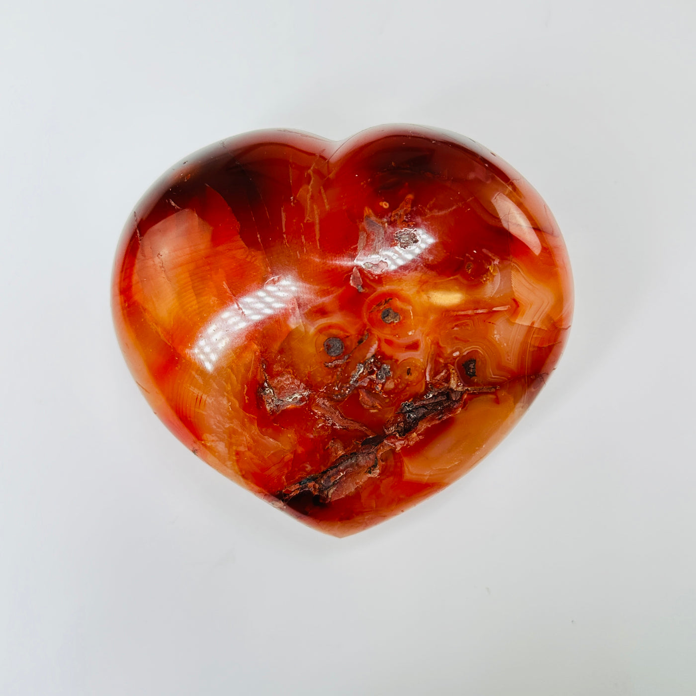 carnelian heart with decorations in the background