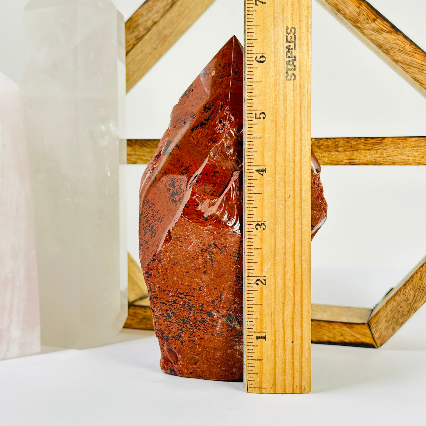 mahogany obsidian point with decorations in the background