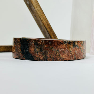 feldspar and tourmaline bowl with decorations in the background