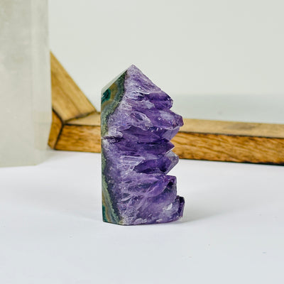 AMETHYST point with decorations in the background