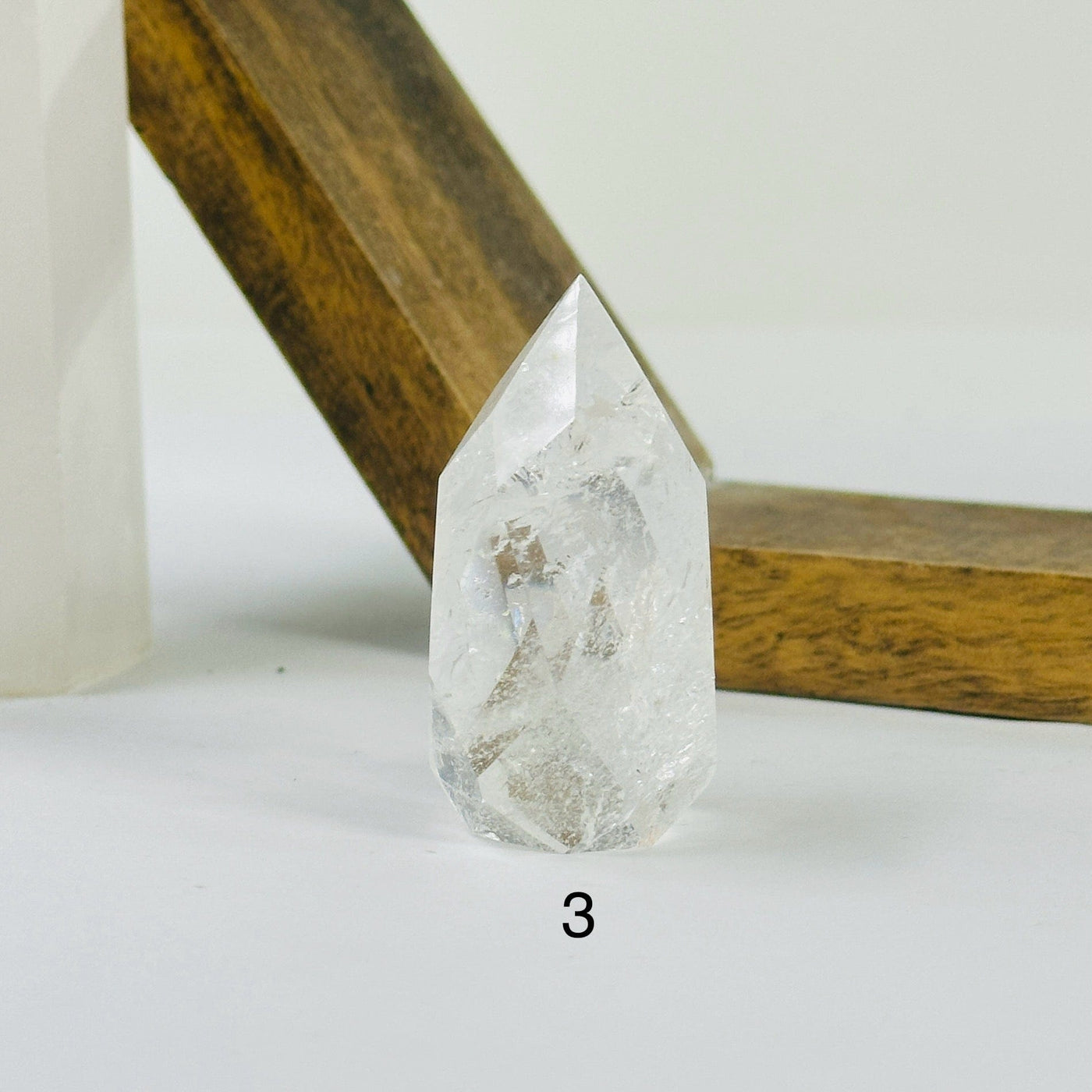 crystal quartz point with decorations in the background