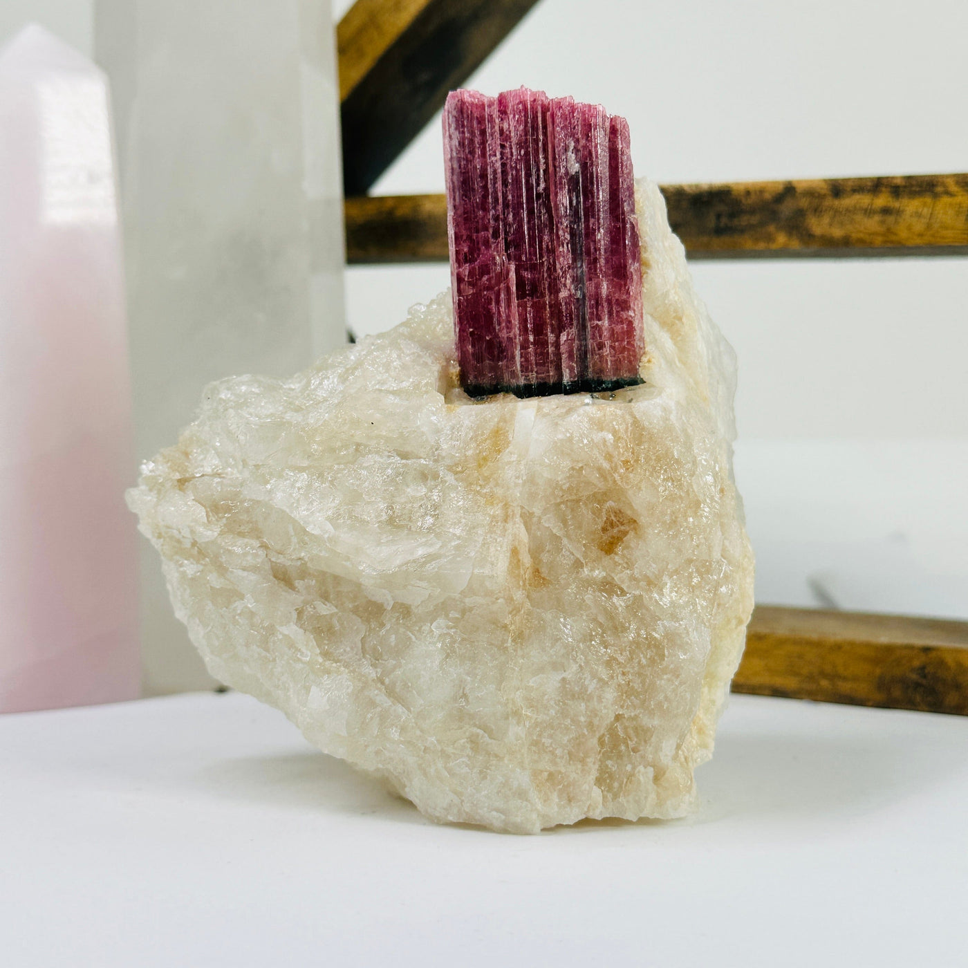 watermelon tourmaline with decorations in the background