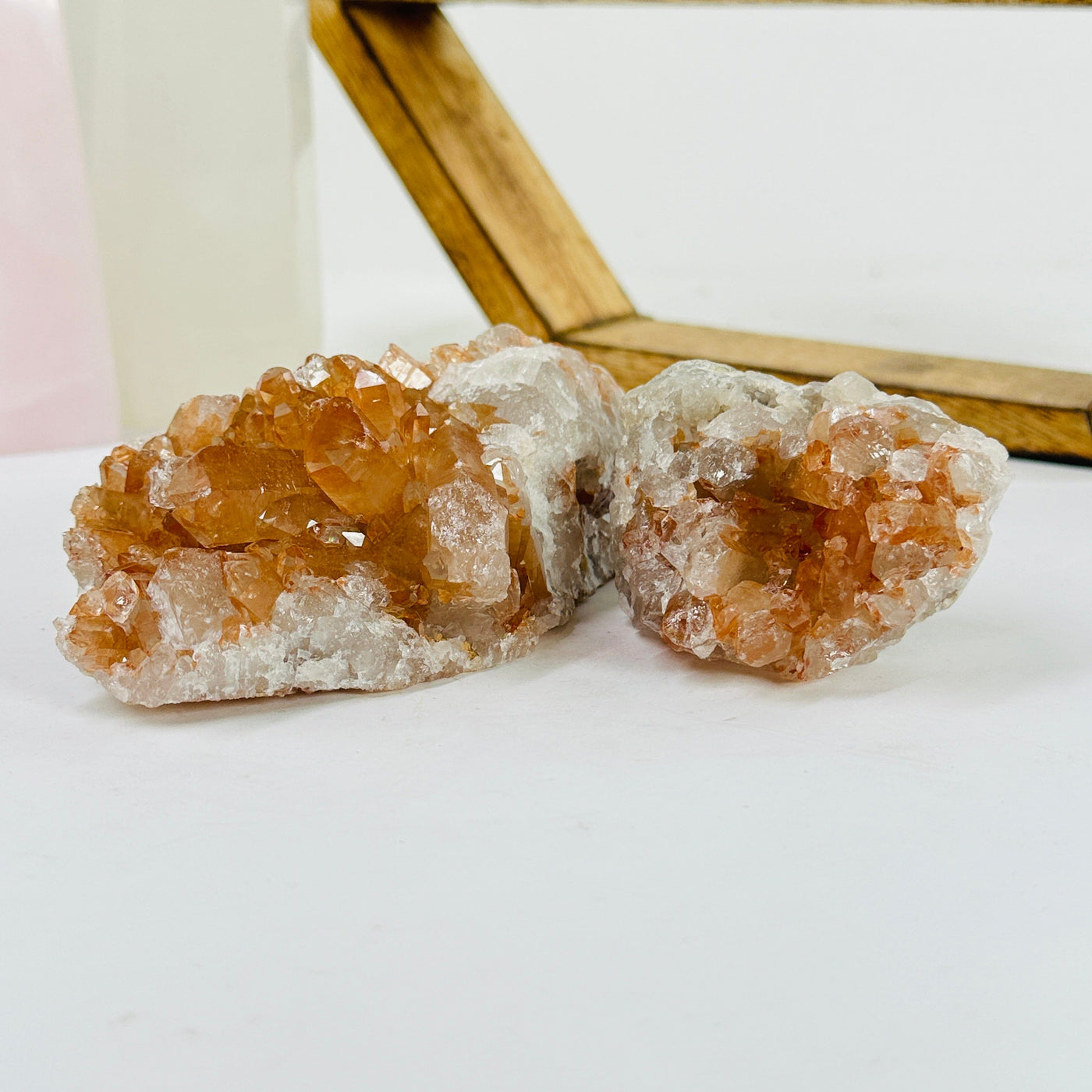 tangerine quartz cluster with decorations in the background