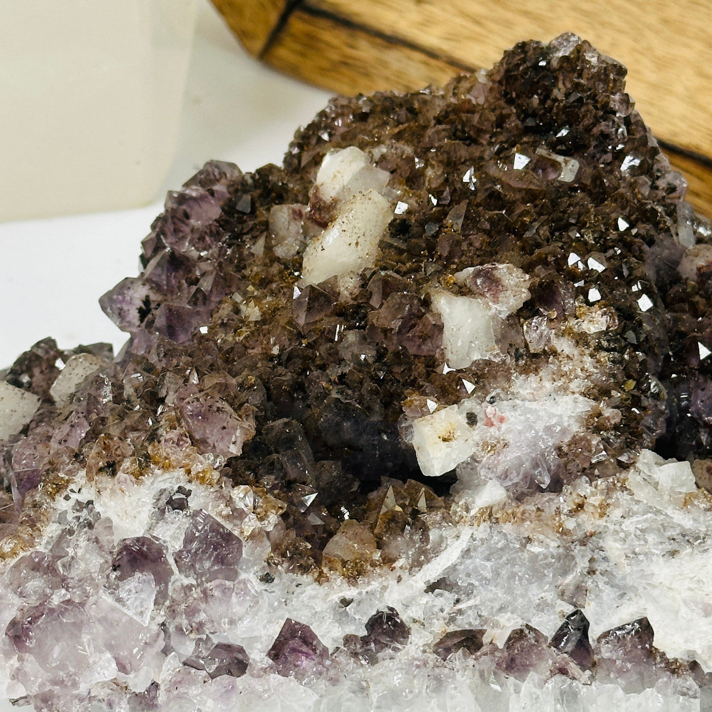 amethyst cluster with decorations in the background