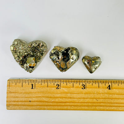 pyrite heart next to a ruler for size reference