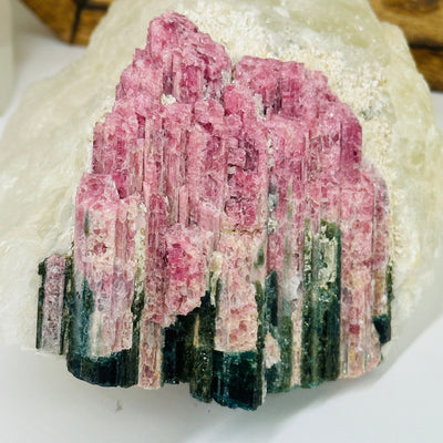 watermelon tourmaline with decorations in the background