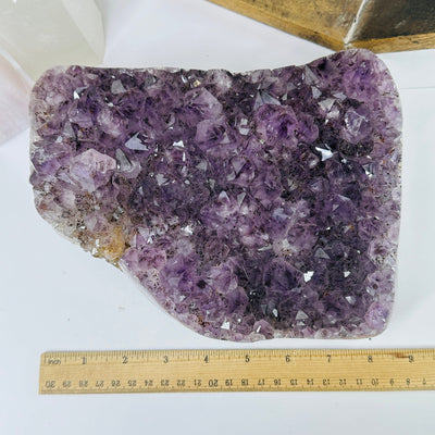 amethyst cluster with decorations in the background