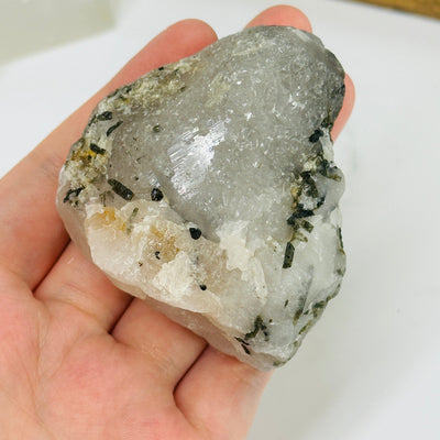 epidote on matrix with decorations in the background