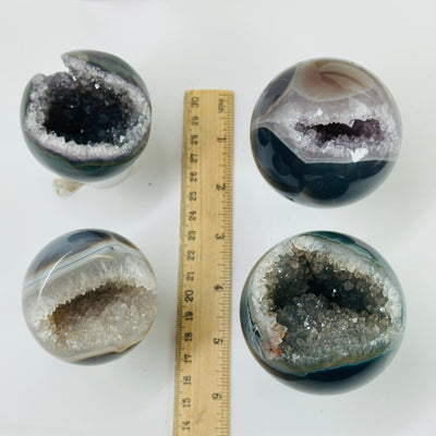 amethyst spheres next to a ruler for size reference