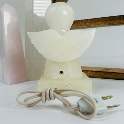 onyx angel lamp with decorations in the background