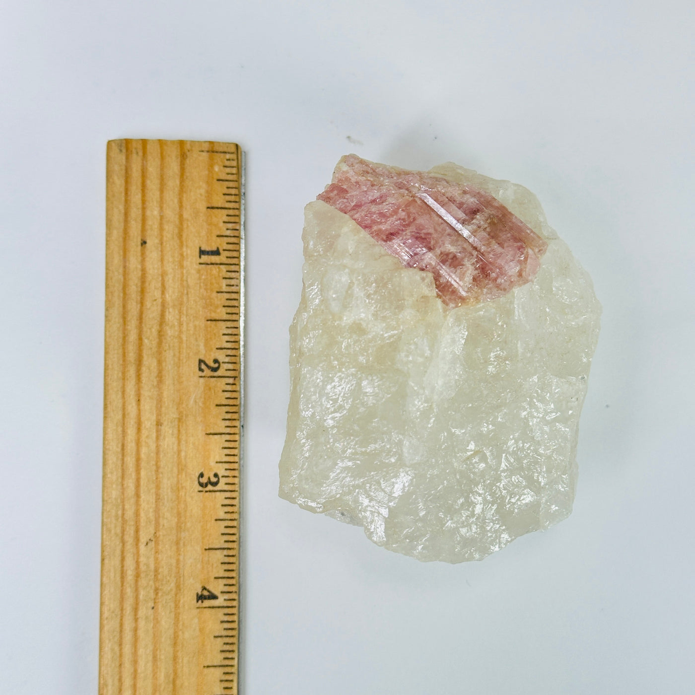 tourmaline next to a ruler for size reference