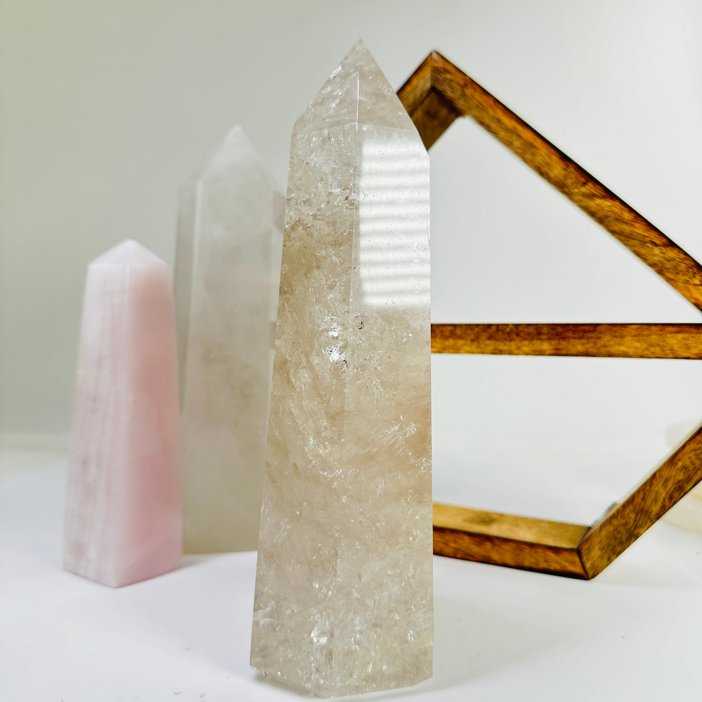 crystal quartz point with decorations in the background