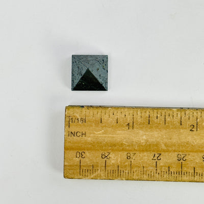 hematite pyramid next to a ruler for size reference