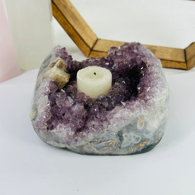 amethyst candle holder with decorations in the background