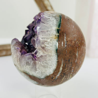 amethyst sphere with decorations in the background