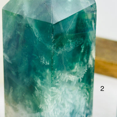 fluorite point with decorations in the background