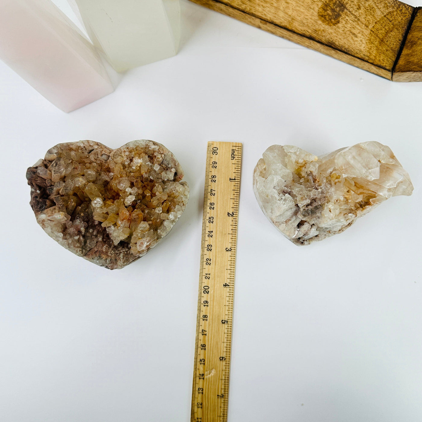 tangerine quartz hearts next to a ruler for size refernce