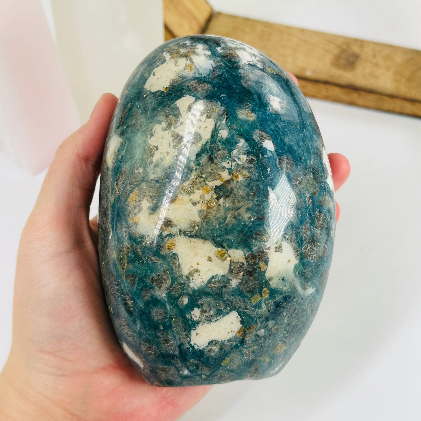 dumortierite cut base with decorations in the background