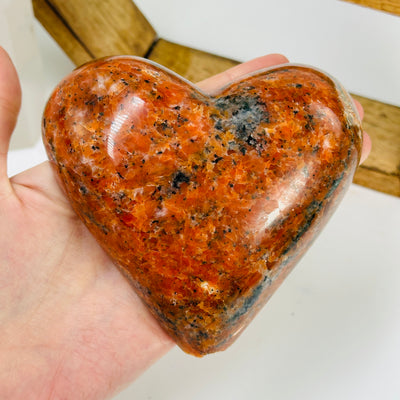 orchid calcite heart with decorations in the background