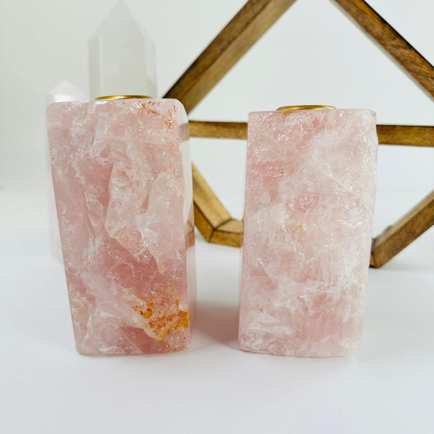 rose quartz tapered candle holder with decorations in the background